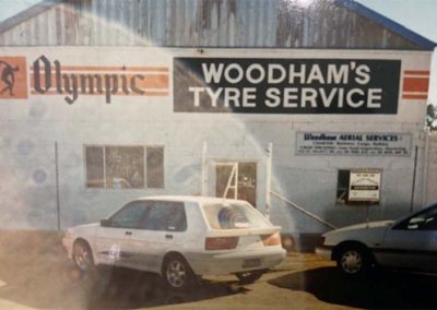 vintage photo - woodhams tyre service shed and white car out front mid 1980's